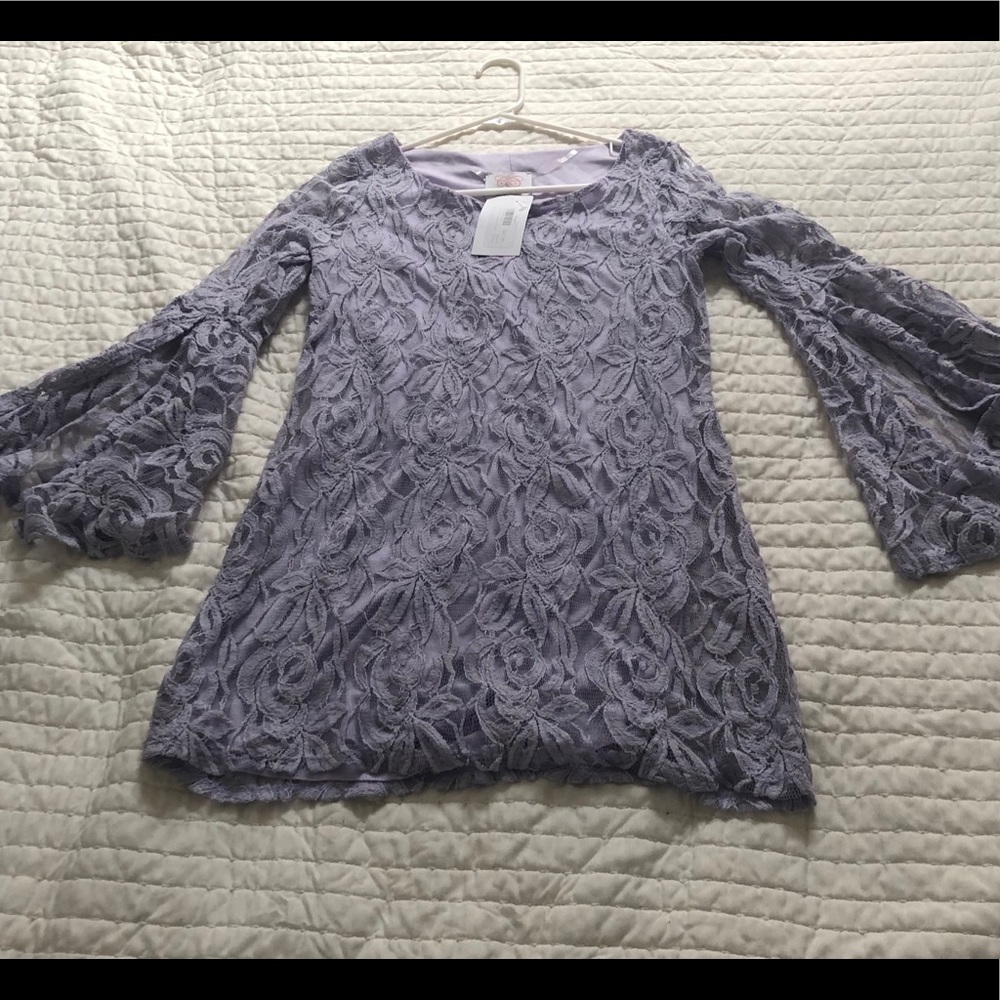 This dress is lavender with bell sleeves.